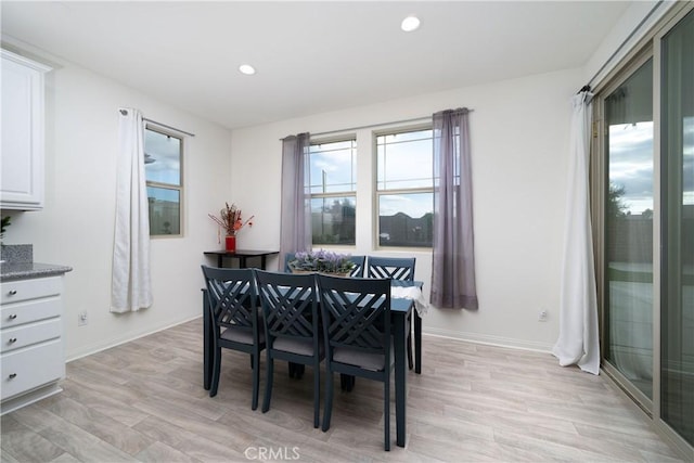 dining space with light hardwood / wood-style floors and a wealth of natural light