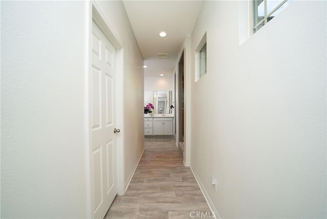 corridor featuring light hardwood / wood-style floors