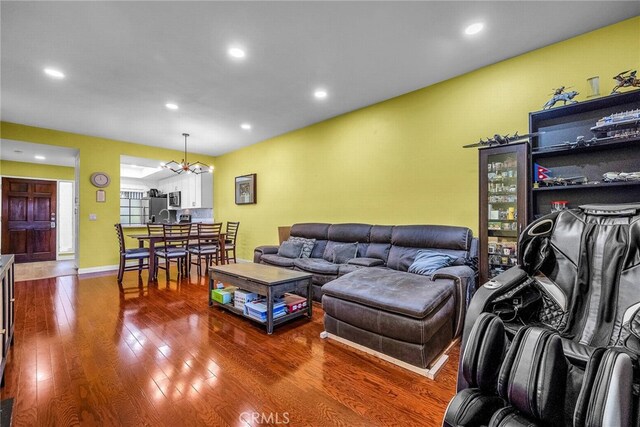 living room featuring hardwood / wood-style floors and an inviting chandelier