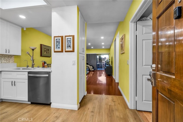 hallway featuring sink and light hardwood / wood-style flooring