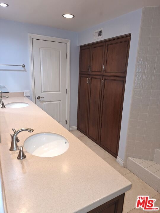 bathroom featuring tile patterned flooring and vanity