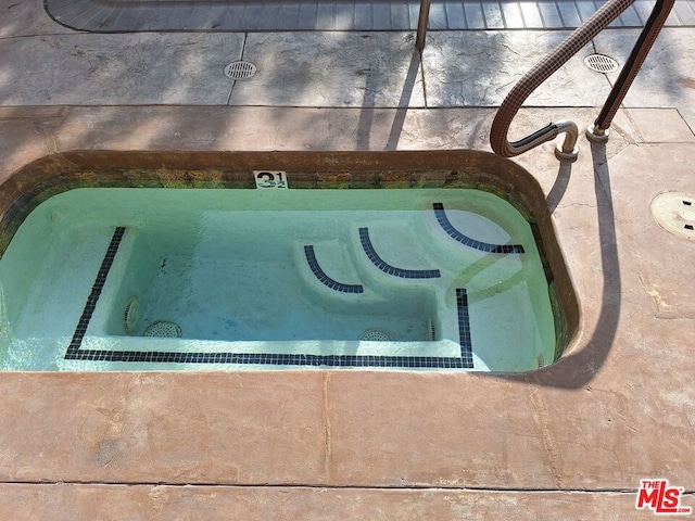 entry to storm shelter featuring a hot tub