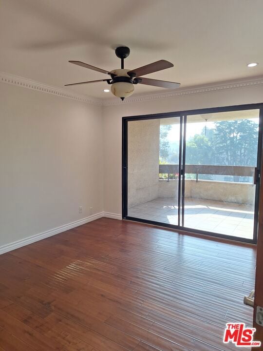 empty room featuring ceiling fan, hardwood / wood-style flooring, and ornamental molding