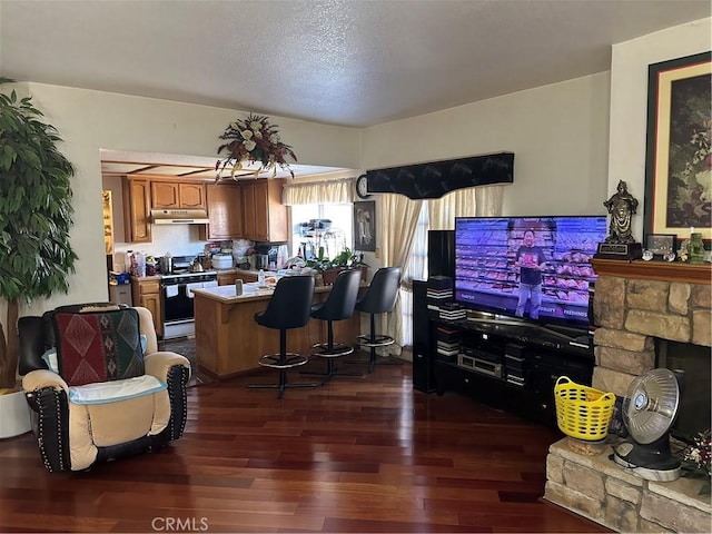 living room with dark wood-style floors and a textured ceiling