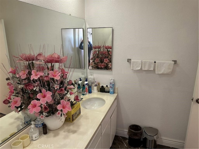 bathroom featuring vanity and baseboards