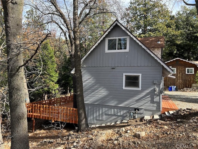 view of side of property with a wooden deck