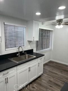 kitchen featuring white cabinetry, ceiling fan, dark wood-type flooring, and sink