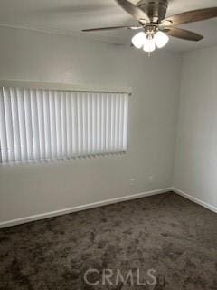 carpeted spare room featuring ceiling fan