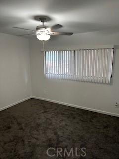 carpeted empty room with ceiling fan