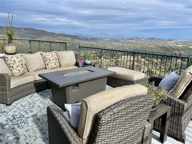 exterior space featuring a mountain view and an outdoor fire pit