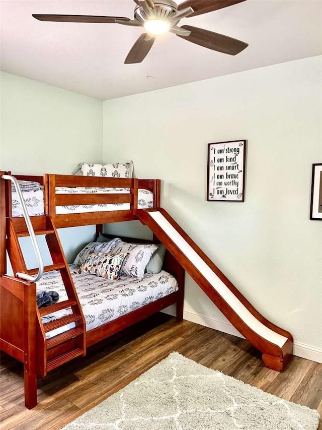 bedroom featuring ceiling fan and dark wood-type flooring