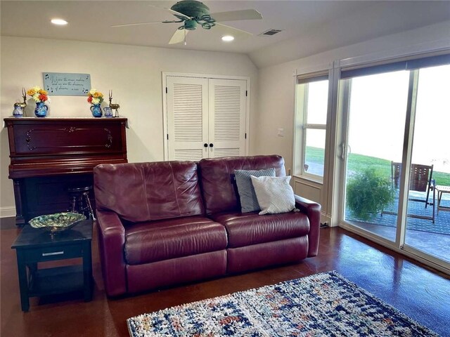 living room with ceiling fan, lofted ceiling, and a wealth of natural light