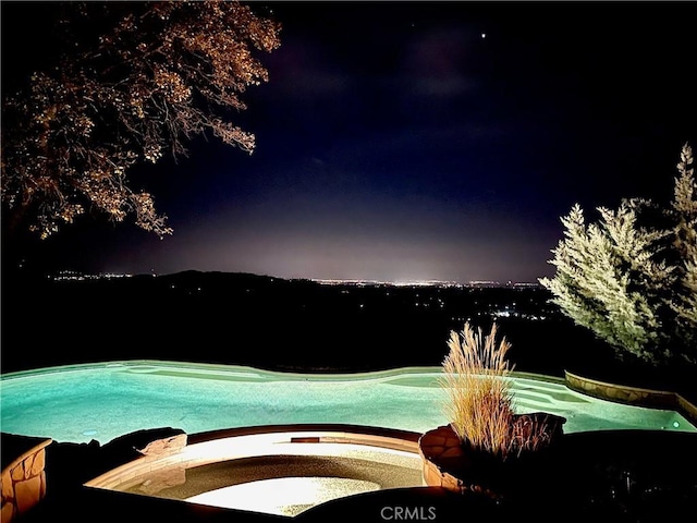 15223 Ledgewood Dr, Redding, CA 96001 - pool at night featuring an outdoor pool