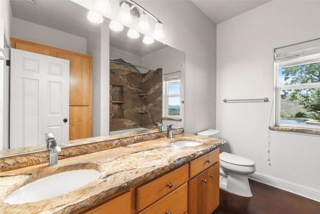15223 Ledgewood Dr, Redding, CA 96001 - bathroom with toilet, double vanity, baseboards, and shower / bath combination