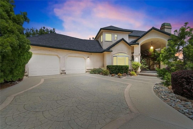 15223 Ledgewood Dr, Redding, CA 96001 - view of front of home with a garage, a chimney, stucco siding, and driveway