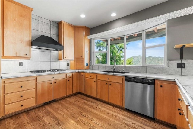 15223 Ledgewood Dr, Redding, CA 96001 - kitchen with dishwasher, gas cooktop, light wood-style floors, wall chimney exhaust hood, and backsplash