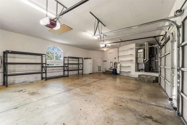 15223 Ledgewood Dr, Redding, CA 96001 - garage with a garage door opener, freestanding refrigerator, and heating unit