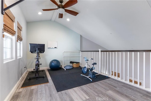 workout area with ceiling fan, lofted ceiling, and light wood-type flooring