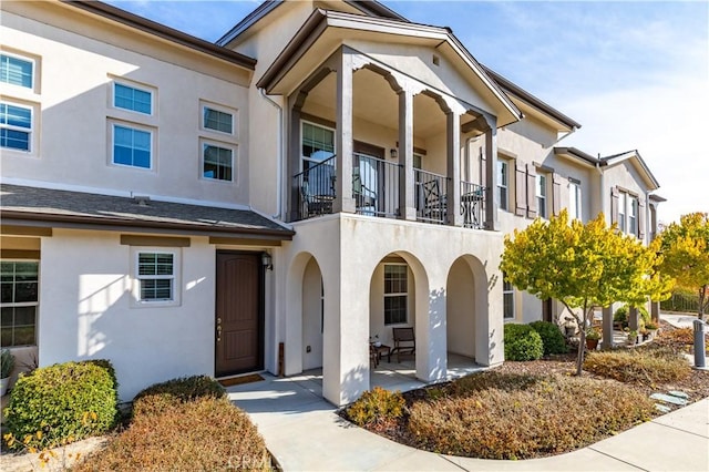 view of front of home with a patio and a balcony