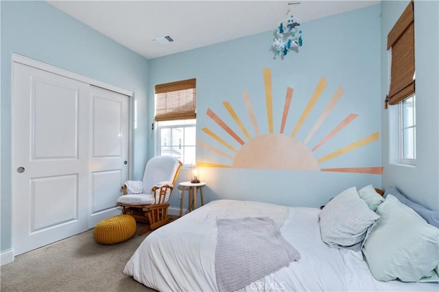 carpeted bedroom featuring a closet