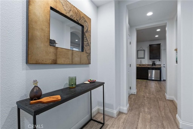 corridor with hardwood / wood-style flooring