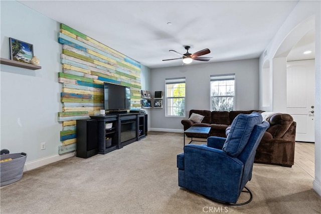 living room featuring light colored carpet and ceiling fan