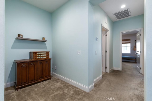 hallway featuring light carpet