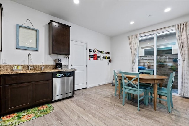 kitchen with light stone countertops, sink, dishwasher, light hardwood / wood-style flooring, and dark brown cabinets