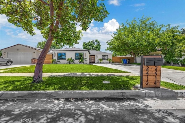 view of front of home featuring a garage and a front lawn