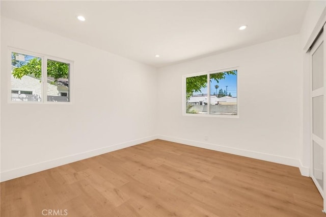 unfurnished room featuring hardwood / wood-style floors and a healthy amount of sunlight