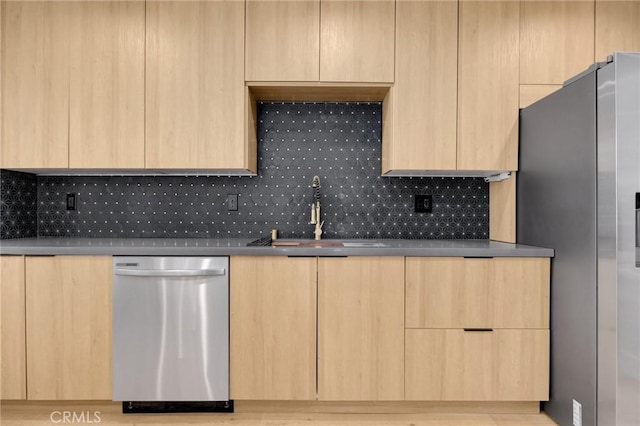 kitchen with light brown cabinets, sink, and appliances with stainless steel finishes