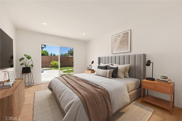 bedroom with access to exterior and light hardwood / wood-style flooring