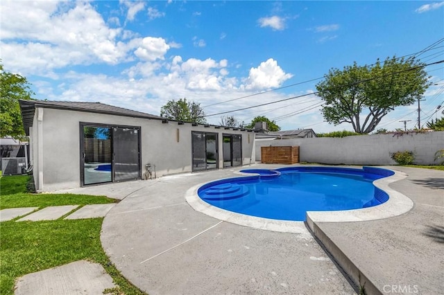 view of pool featuring cooling unit, an in ground hot tub, and a patio