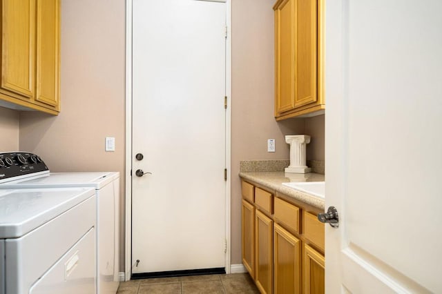 clothes washing area with cabinets, independent washer and dryer, and light tile patterned floors