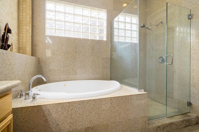 bathroom with vanity and independent shower and bath