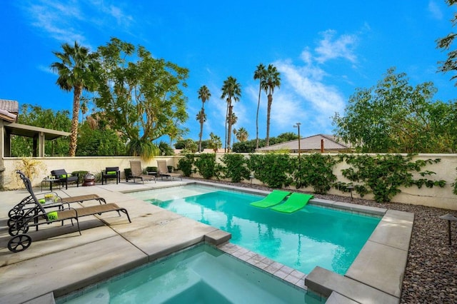 view of swimming pool with an in ground hot tub and a patio