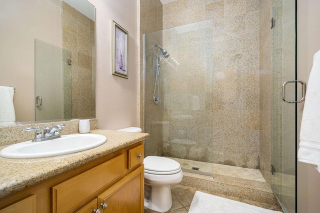 bathroom with vanity, toilet, and a shower with shower door