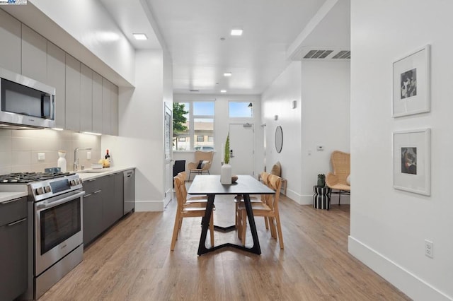 dining space featuring light hardwood / wood-style floors and sink