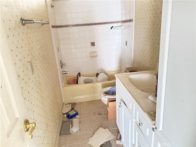 full bathroom featuring tile patterned flooring, vanity, toilet, and tiled shower / bath