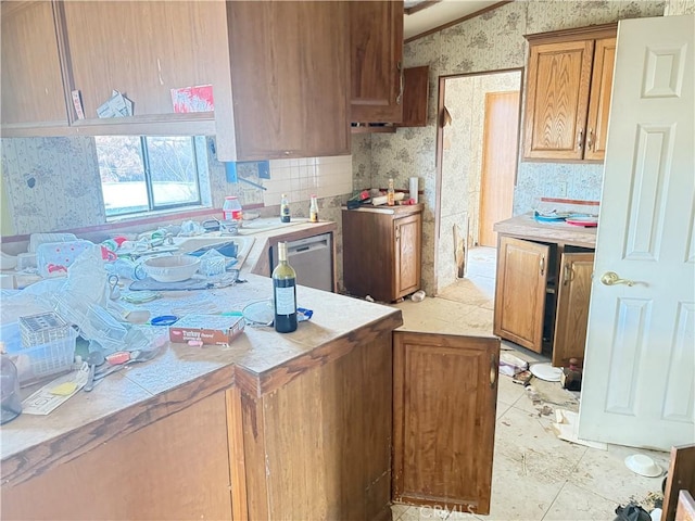 kitchen with stainless steel dishwasher and lofted ceiling