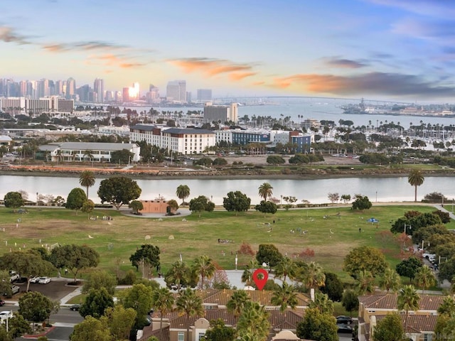 aerial view at dusk featuring a water view