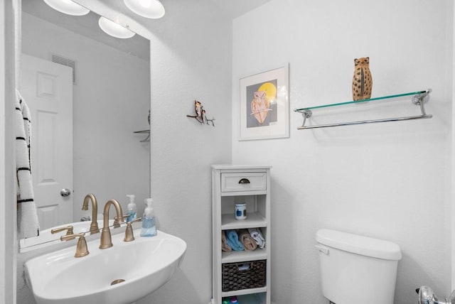 bathroom featuring sink and toilet