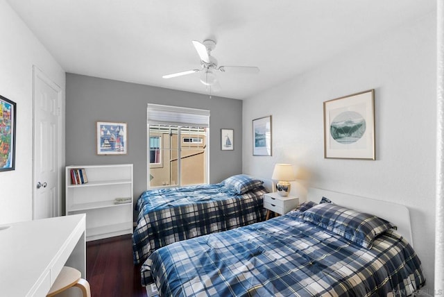 bedroom with dark hardwood / wood-style floors and ceiling fan