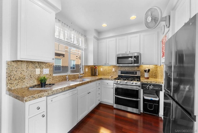 kitchen featuring sink, dark hardwood / wood-style flooring, white cabinets, stainless steel appliances, and backsplash