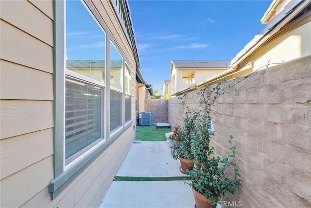 view of side of property featuring a patio and cooling unit