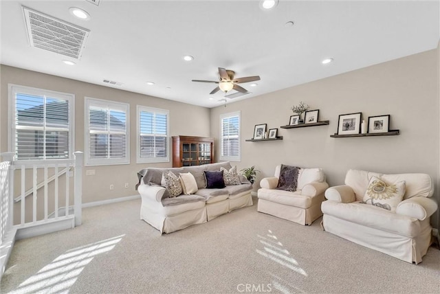 carpeted living room featuring ceiling fan