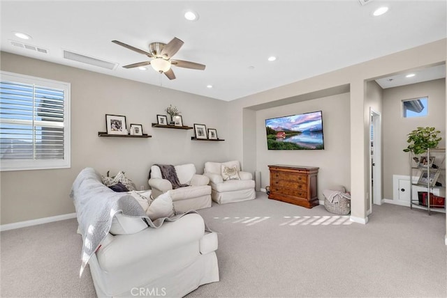 carpeted living room featuring ceiling fan