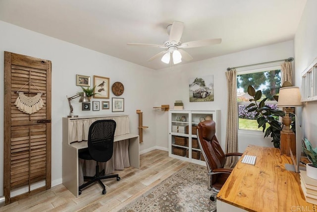 office space with baseboards, a ceiling fan, and wood finished floors