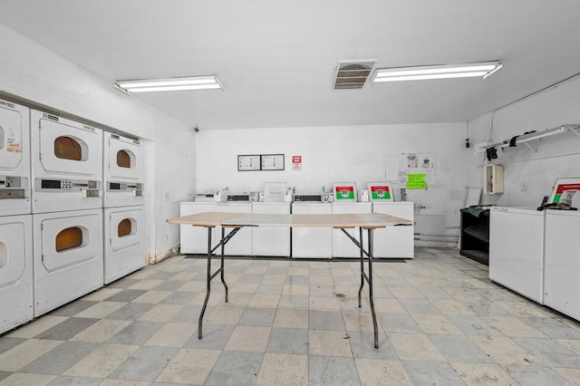 laundry area with washer and clothes dryer and stacked washer / dryer