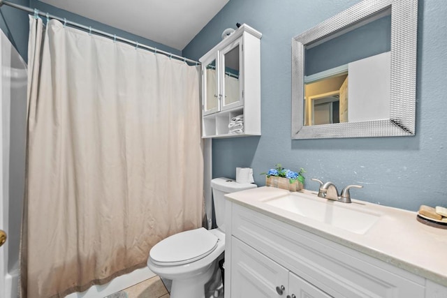 full bathroom featuring tile patterned floors, vanity, toilet, and shower / tub combo